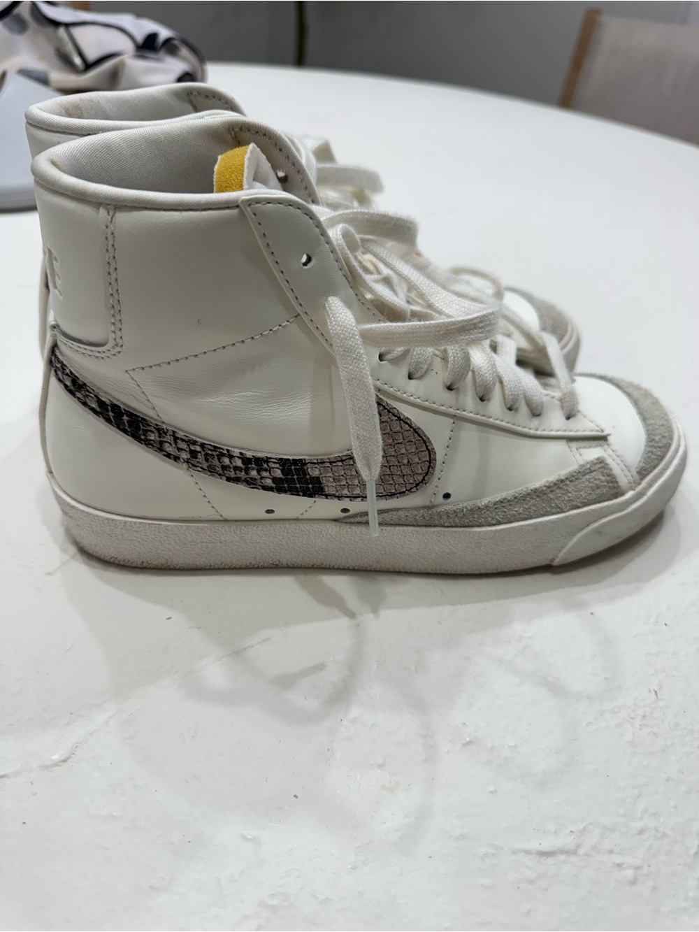 Nike White High-Top Sneakers with Black Swoosh and Yellow Tongue Accent